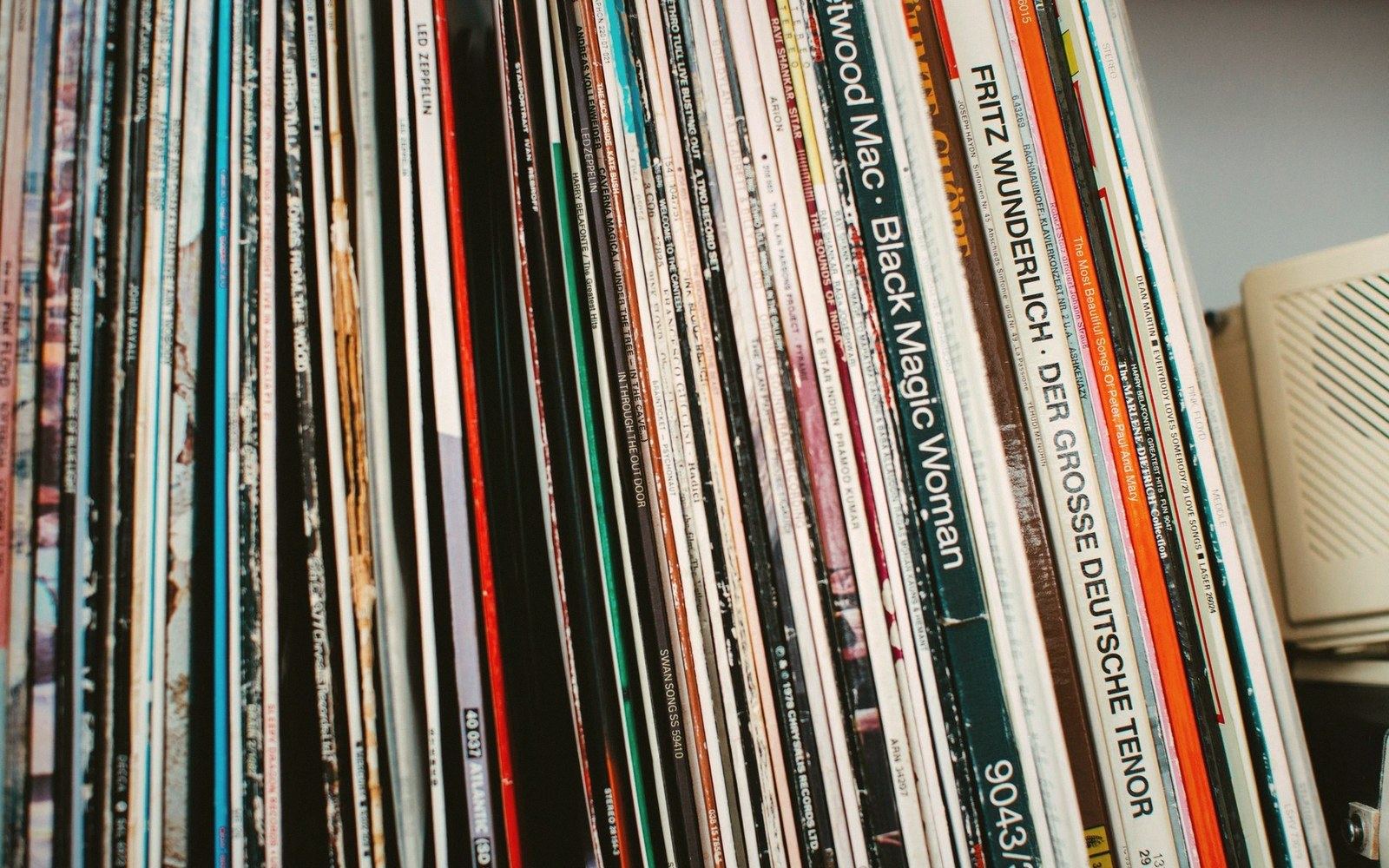 Rows of vinyl record albums packed tightly together on a shelf